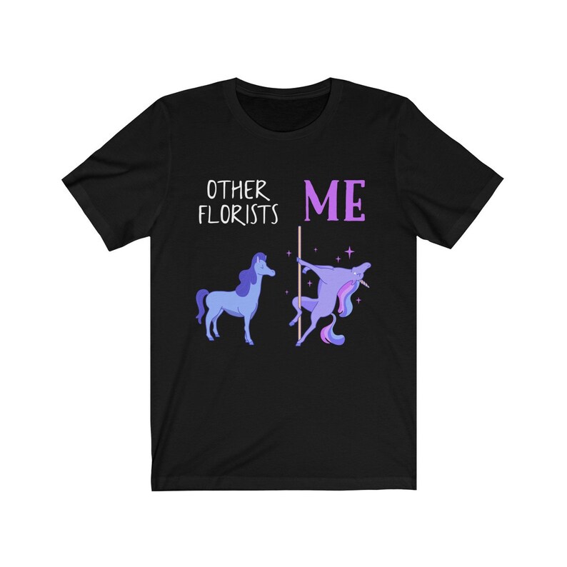 May include: Black t-shirt with a humorous graphic comparing other florists to a regular unicorn and the wearer to a unicorn doing a pole dance. The text reads "Other Florists" and "Me".