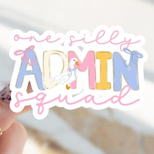 May include: A sticker with the words "one silly ADMIN squad" in pink script. The word ADMIN is in blue, pink, and yellow block letters. A cartoon goose wearing a blue bow is in the center. The sticker has a white background.