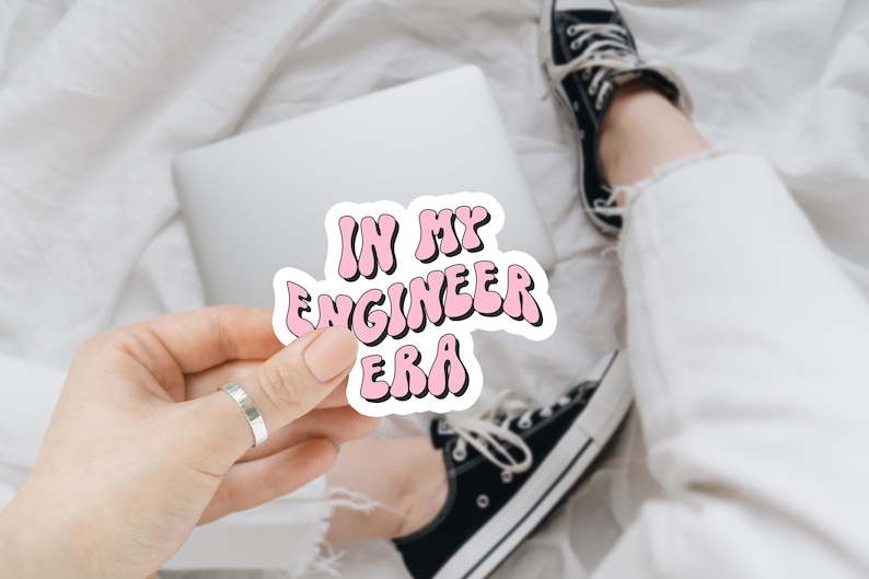 May include: Pink sticker with the text "IN MY ENGINEER ERA" in a wavy font.