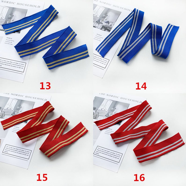 May include: Four samples of elastic trim with gold and silver stripes. The trim is blue, red, blue, and red. The trim is arranged in a zig-zag pattern. The numbers 13, 14, 15, and 16 are printed below each sample.