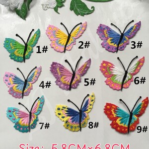 May include: Nine embroidered butterfly patches in various color combinations, each featuring black antennae and measuring 5.8 cm by 6.8 cm. The patches are labeled 1# through 9# and display intricate thread work in shades of pink, blue, yellow, green, and red.