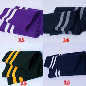 May include: Four folded knitted scarves in different colors: purple with white stripes, navy with gray stripes, dark green with yellow stripes, and navy with white stripes. Each scarf has a number printed on it.