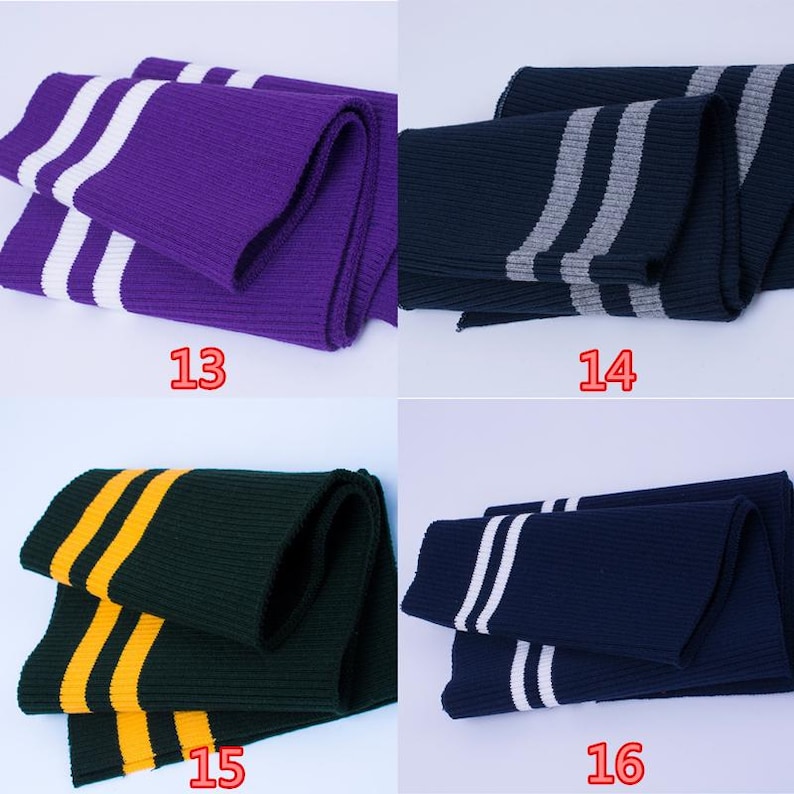 May include: Four folded knitted scarves in different colors: purple with white stripes, navy with gray stripes, dark green with yellow stripes, and navy with white stripes. Each scarf has a number printed on it.