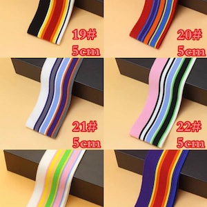 May include: Assortment of 10 striped elastic bands in various colors, including red, blue, green, yellow, white, black, and pink. The bands are 5 cm wide and are labeled with numbers 19 through 24.