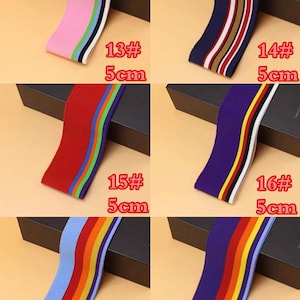 May include: Six different types of elastic trim with colorful stripes. Each trim is 5 cm wide and is labeled with a number and the width. The trims are pink, navy blue, red, purple, light blue, and dark purple.