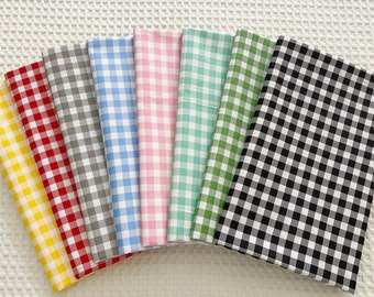 May include: Eight fabric swatches with a gingham pattern in various colors, including yellow, red, gray, light blue, pink, green, and black and white.