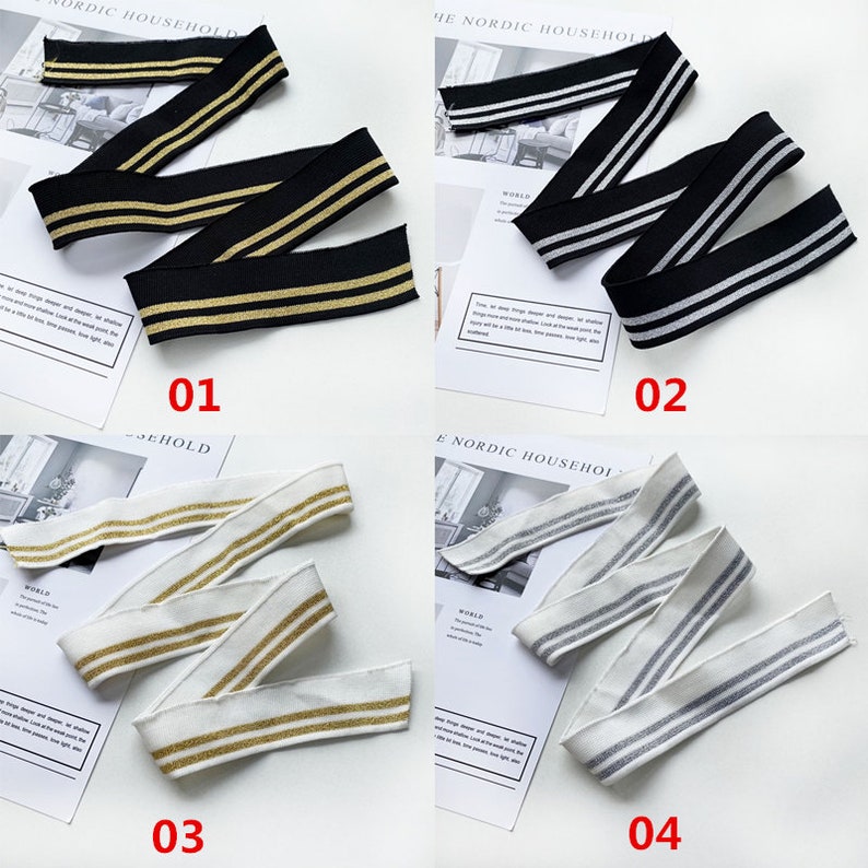 May include: Four samples of elastic trim with two stripes. The trim is available in black with gold stripes, white with gold stripes, white with silver stripes, and black with silver stripes.