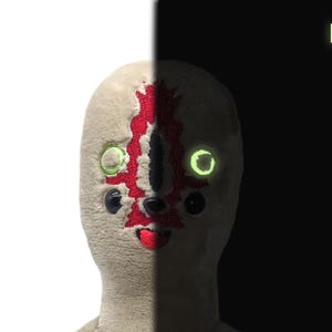 Puede incluir: Un juguete de peluche con una cara blanca y costuras rojas, que se asemeja a una criatura con ojos verdes brillantes. El juguete est&aacute; dividido en dos, con un lado en un fondo blanco y el otro en un fondo negro. El texto "LUM" es visible en el fondo negro.