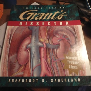 May include: A medical textbook cover with a detailed illustration of the human anatomy, including the kidneys, aorta, vena cava, and spleen. The title of the book is "Grant's Dissector" and the author is "Eberhardt K. Sauerland".