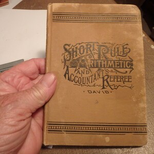 May include: A vintage book titled "Short Rule Arithmetic and Accountant's Referee" by David.