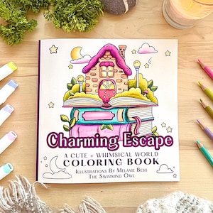 May include: A coloring book titled "Charming Escape: A Cute + Whimsical World Coloring Book" with illustrations by Melanie Bess, The Swimming Owl. The cover features a whimsical illustration of a house built on top of a stack of books.