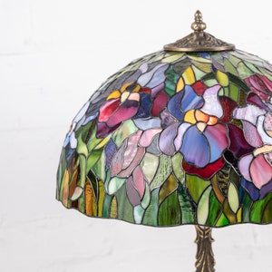 the bronze cap on the stained glass lamp