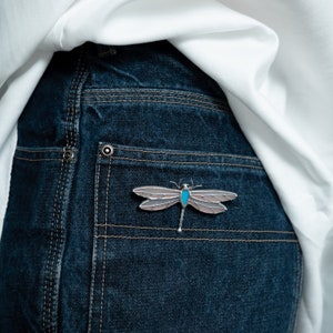 dragonfly stained glass pin on the jeans