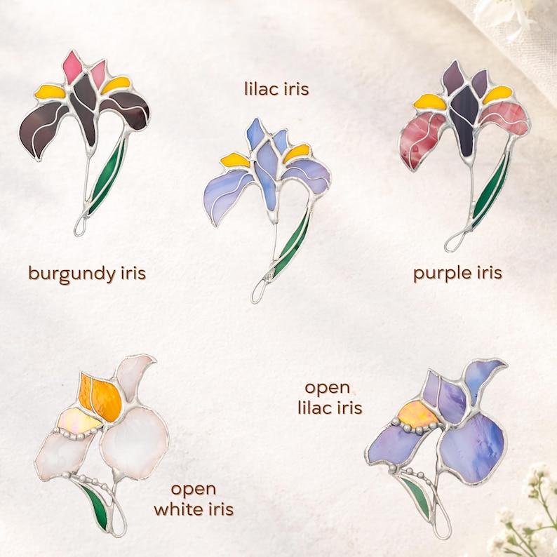Stained glass flower brooch collection showing different designs of iris flower, handmade botanical jewelry pins assortment, floral gift options.