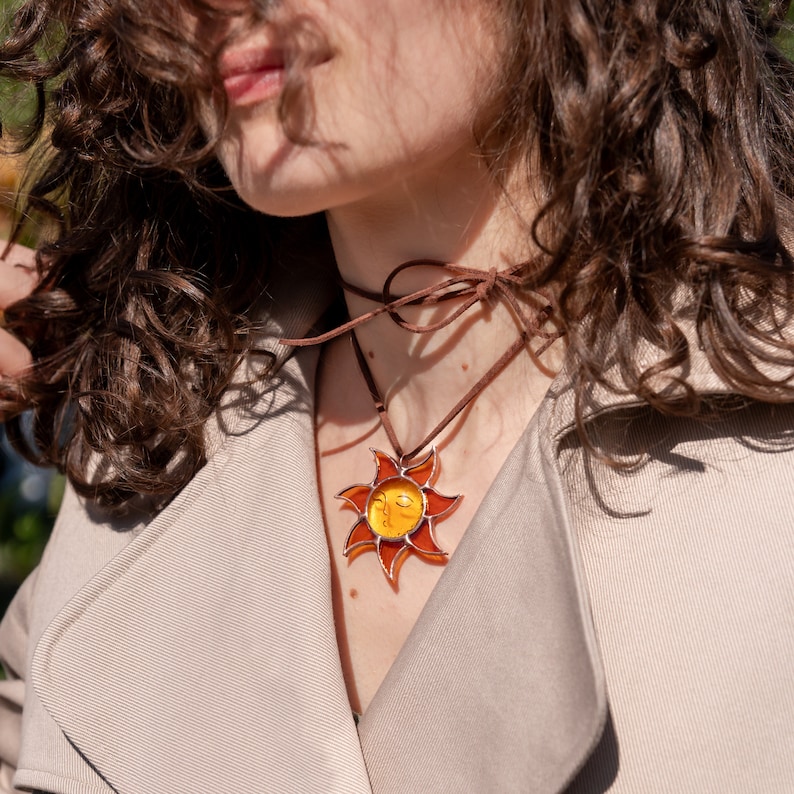 girl with stained glass sun necklace