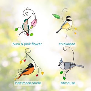 Collage of four stained glass hanging bird ornaments including a hummingbird with a pink flower, chickadee, Baltimore oriole, and titmouse.