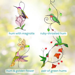 Decorative stained glass birds in vibrant colors, perched on elegant wire branches with leaves and berries, creating a nature-inspired wall or window display.