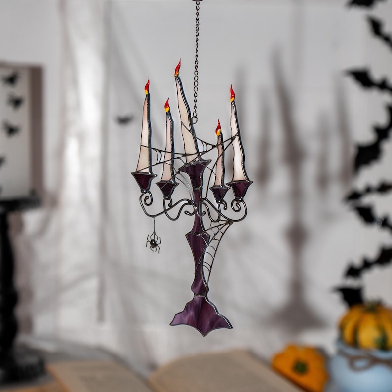 Stained glass suncatcher with glowing candles in warm colors