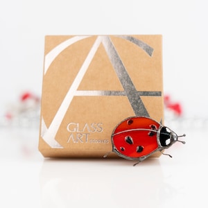 ladybug stained glass pin in the brand box of Glass Art Stories