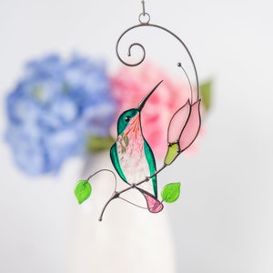the green hummingbird with the pink flower made of modern stained glass