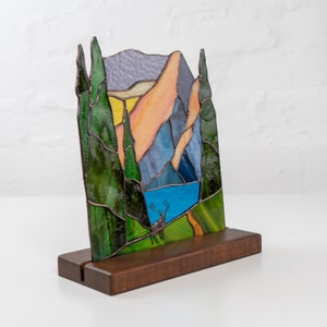 Stained glass light catcher on the wooden base