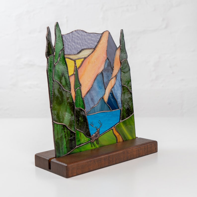 Stained glass light catcher on the wooden base