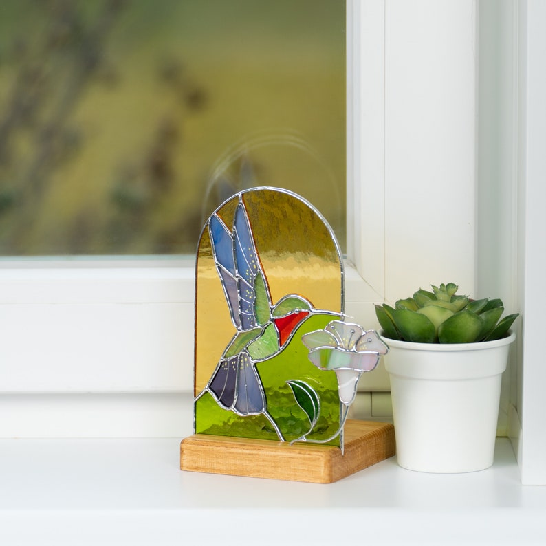 decoration the the window sill - stained glass panel with candle holder