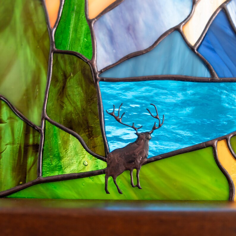 the deer made of brass on the stained glass