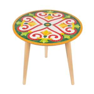 May include: A round side table with a mosaic top featuring a green, red, yellow, and white floral design. The table has three wooden legs.