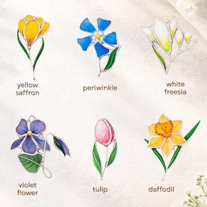 Stained glass flower brooch collection showing different designs, handmade botanical jewelry pins assortment, floral gift options.