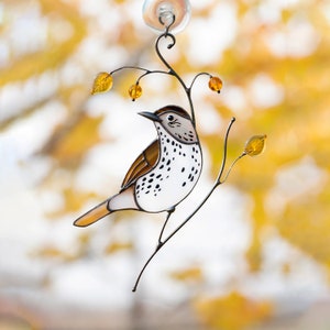 handmade glass bird ornament on the branch