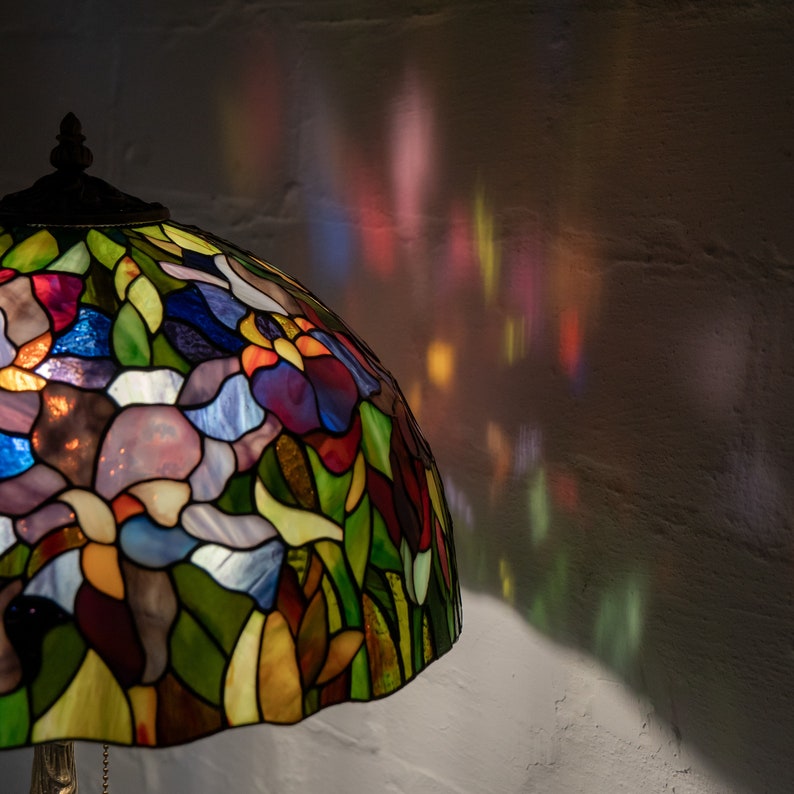 the bright and colorful light from the stained glass lamp
