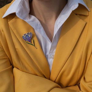 saffron pin made of stained glass on the orange coat