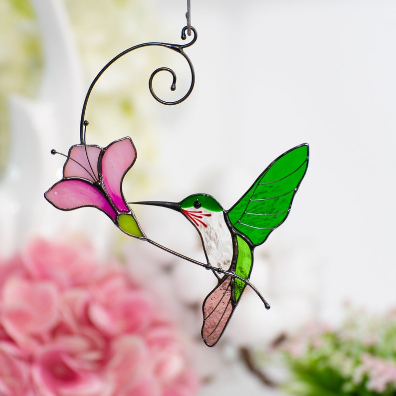 flying green hummingbird with the pink flower stained glass hanging for window