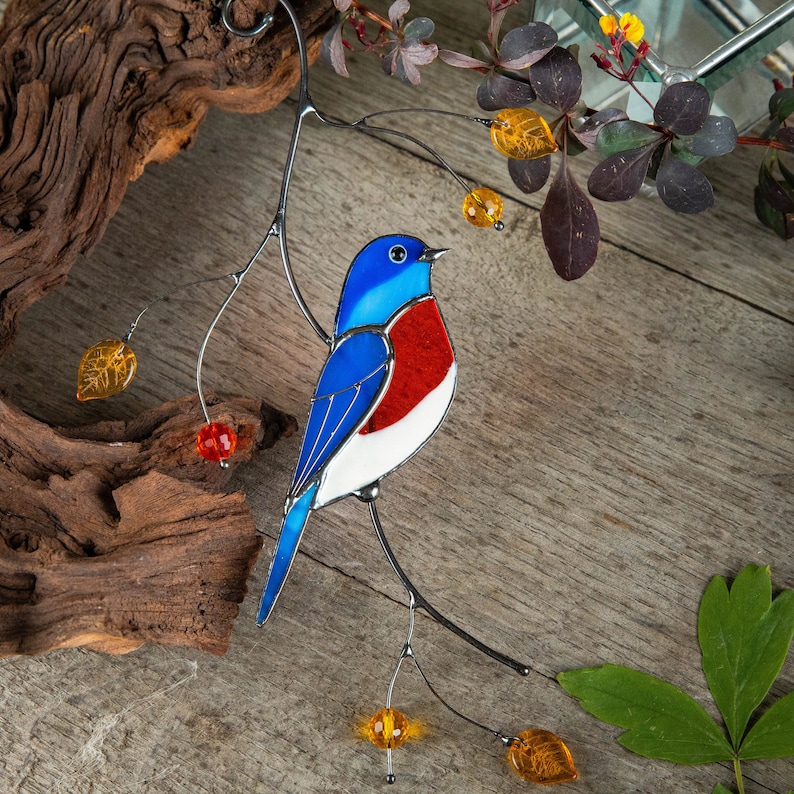suncatcher of stained glass bluebird on the branch