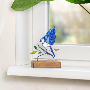 modern stained glass blue jay decor on a windowsill