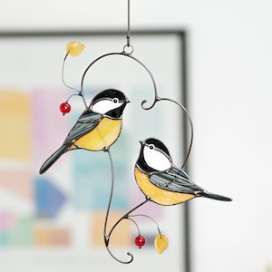 two chickadees sitting on the branch in heart shape stained glass light catcher