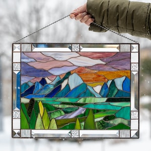 Custom stained glass window with beveled frame and mountains