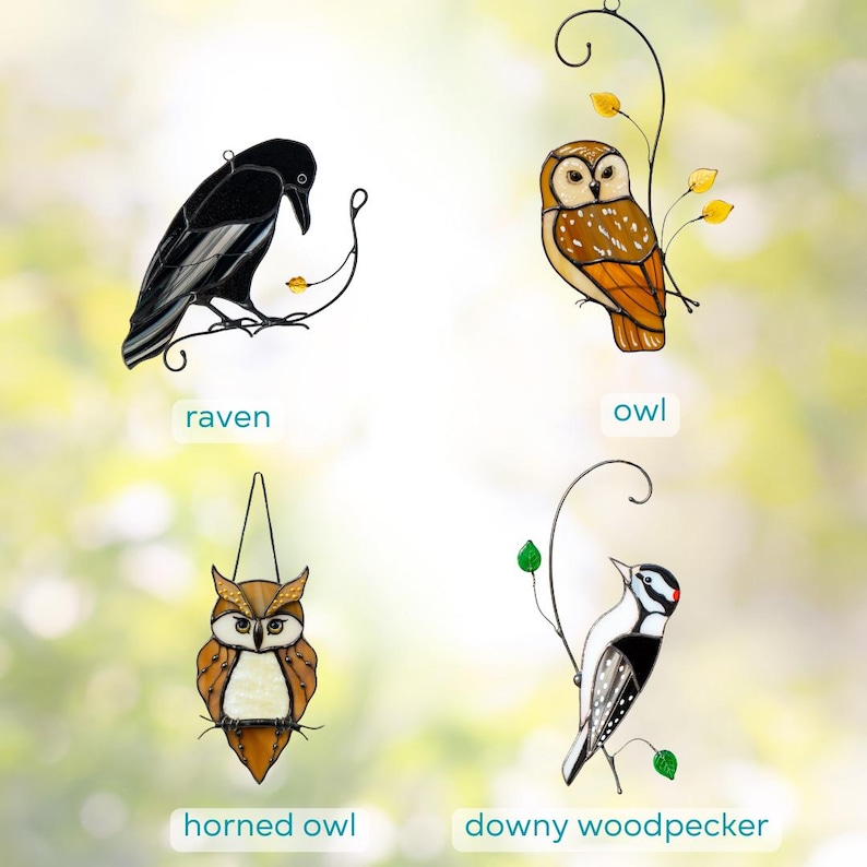Stained glass bird suncatchers collection on decorative metal branches against a soft blurred background.