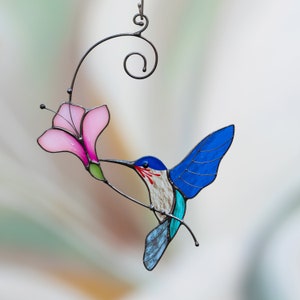 flying blue hummingbird with the pink flower made of stained glass