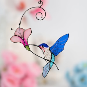 flying blue hummingbird with the pink flower stained glass hanging for window