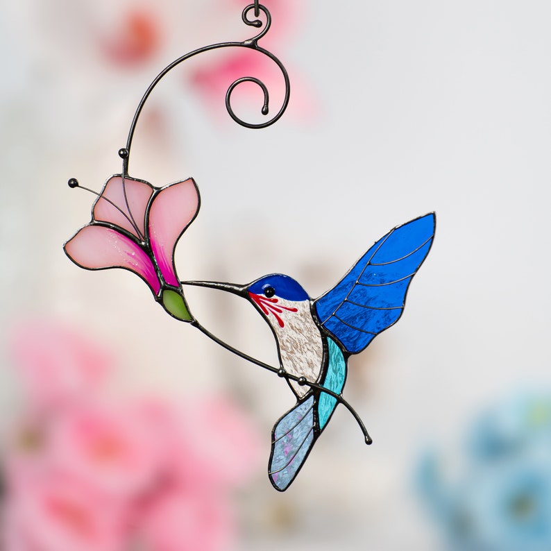 flying blue hummingbird with the pink flower stained glass hanging for window