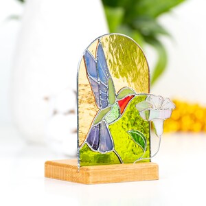 vibrant stained glass hummingbird panel that could be used as candle holder