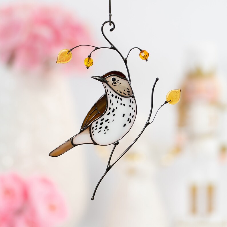 stained glass wood thrush on the branch