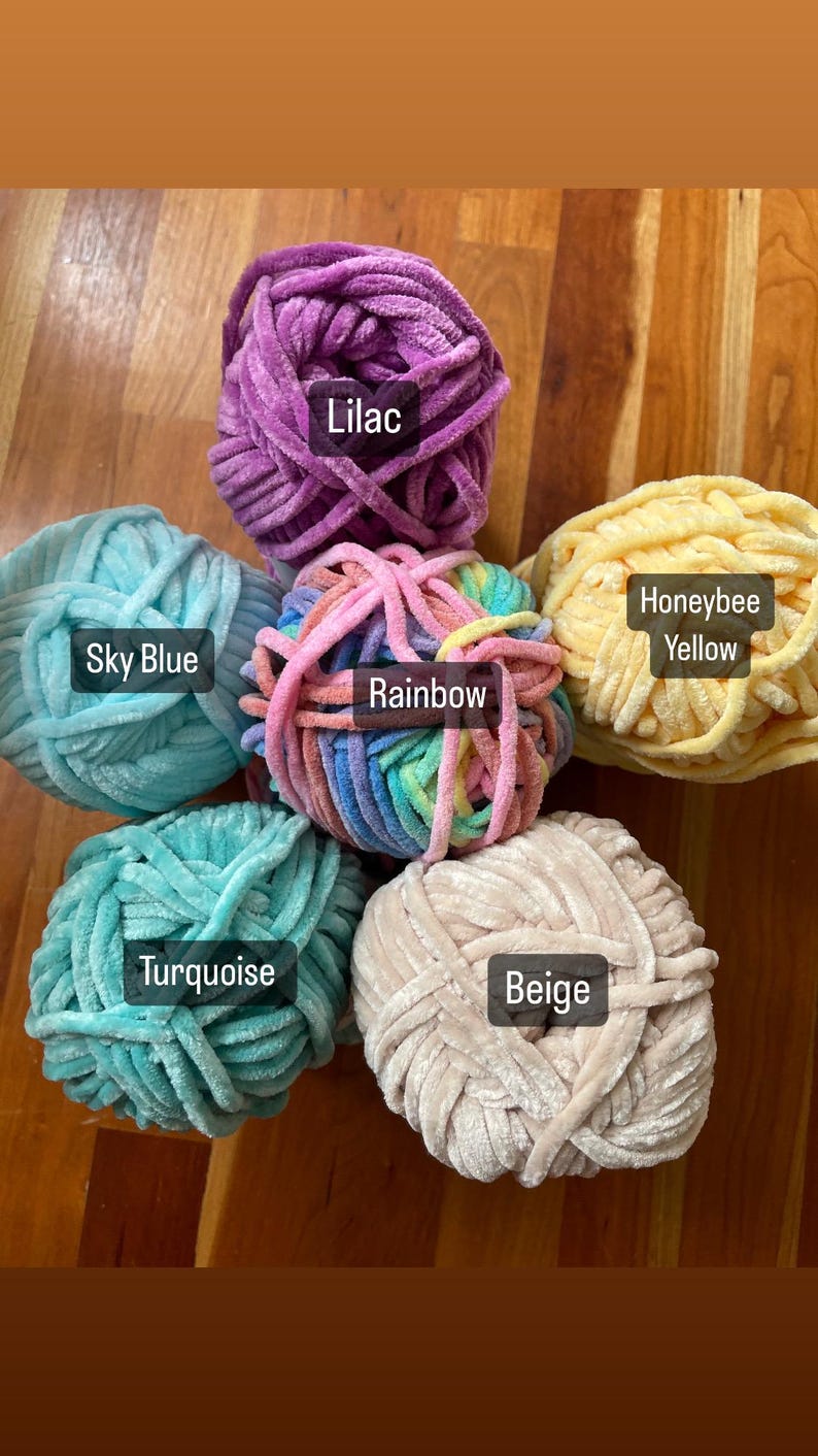 May include: Six balls of yarn in different colours: lilac, sky blue, rainbow, turquoise, beige, and honeybee yellow. The yarn is soft and fluffy, perfect for knitting or crocheting.