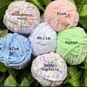 May include: Six balls of yarn in various colours and patterns, including pink, white, blue, green, pastel confetti, and strawberry swirl.
