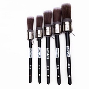 May include: A set of five paint brushes with black handles and silver ferrules. The brush heads are brown with white tips. Each handle has the text "CLING ON!" and a size indicator. The brushes are arranged from smallest to largest.