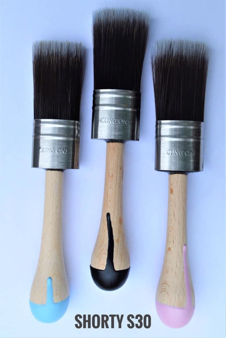 May include: Three paint brushes with natural wood handles and black bristles. The metal ferrules are stamped with "CLING ON!". The handles are painted at the base in blue, black, and pink. The text "SHORTY S30" is at the bottom.