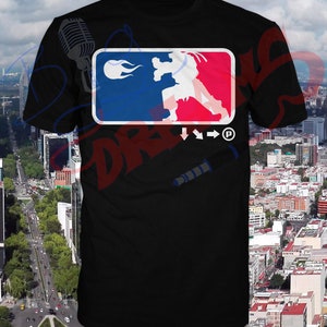 May include: Black t-shirt with a graphic of a fighting video game character in a blue and red logo with flames. The logo also includes the text "Street Fighter" and a copyright symbol.