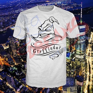 May include: White t-shirt with a black and white illustration of the Sorting Hat from the Harry Potter series. The hat is wearing a frown and the text "Gryffindor" is written on a banner below the hat.